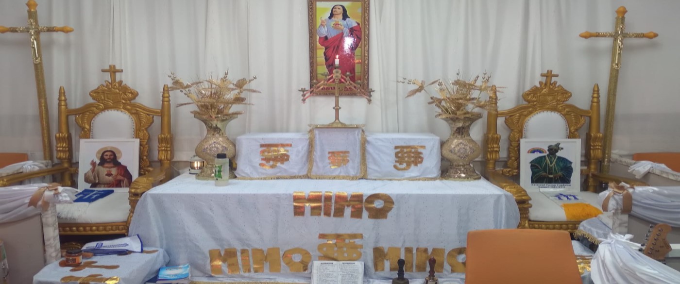 Church altar with white cloths and gold furnishings